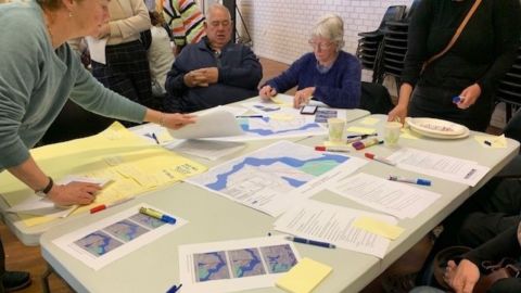 people at a table with maps and documents