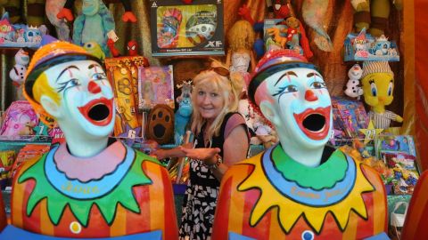 Two clown heads in front of prize stand