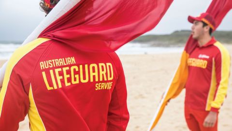 two people in red and yellow lifeguard uniforms