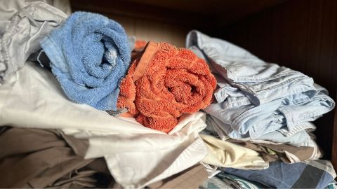 towels and sheets in a cupboard