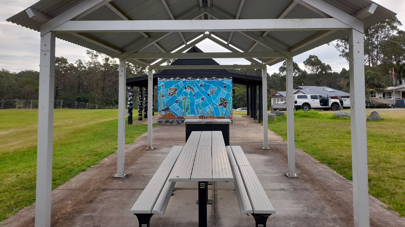Image Large covered bbq and seating area.