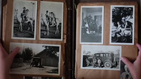Old family history photos in an old photo album.
