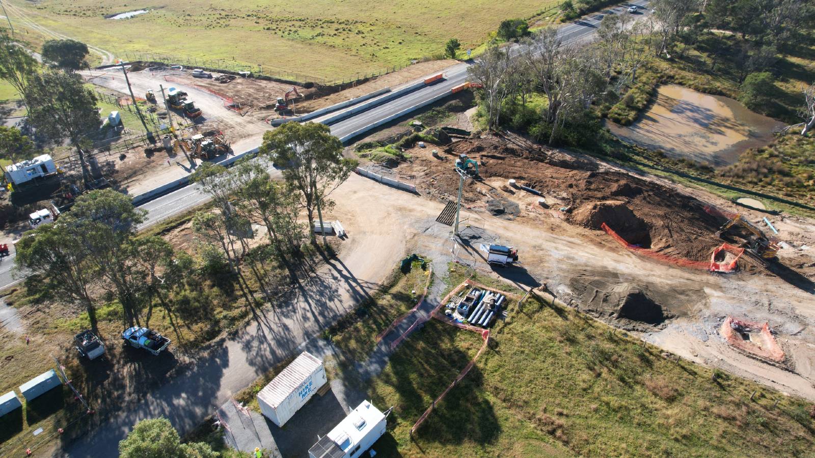 Image A drone image shows a sealed road with earthworks underway on either side