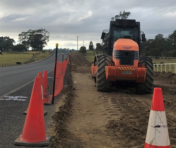 Heavy plant levelling the side of the road