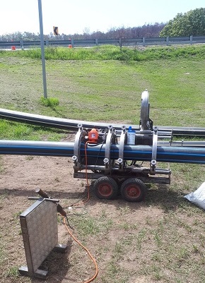 A machine welds two lengths of pipe together