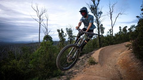 Mountain biker in the air on trails 
