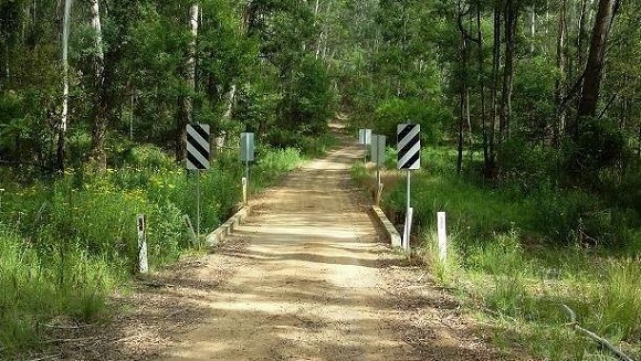 Image The timber bridge sits in a green setting