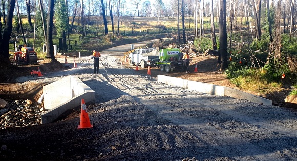 Image Loosely laid gravel forms rough road over concrete culverts