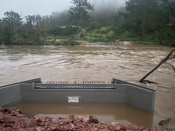 Image A river is in flood in a bushland setting