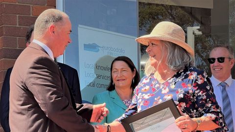 Man getting award from woman