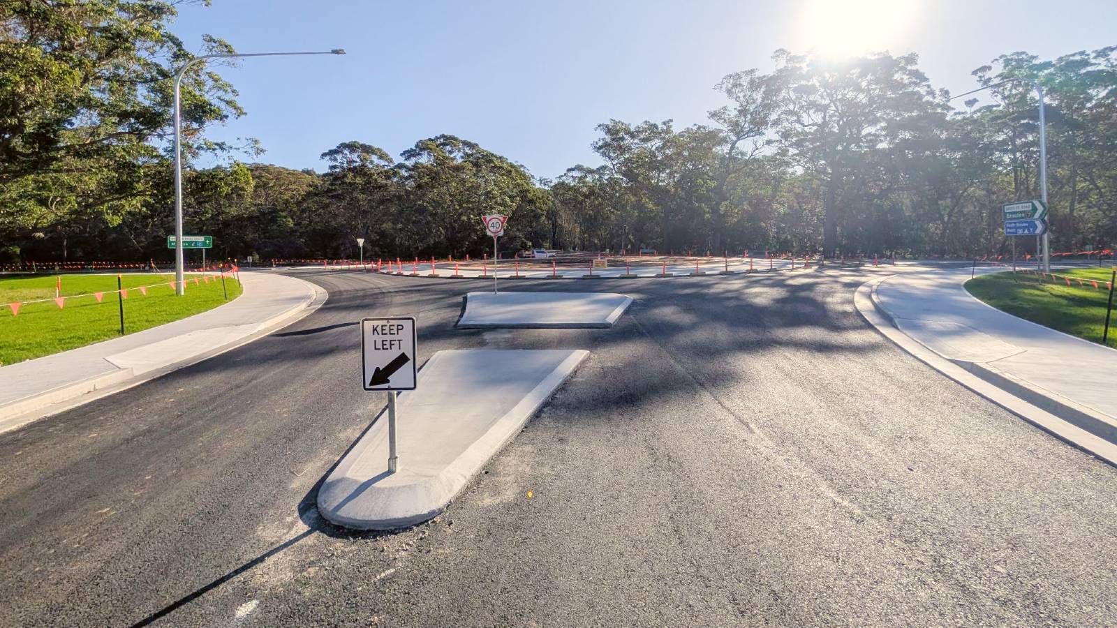 Image Concrete traffic islands on a newly laid road surface.