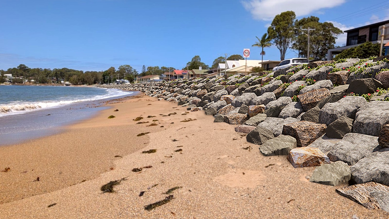 A visualisation shows a rock seawall along a beach with cars and houses behind the wall.