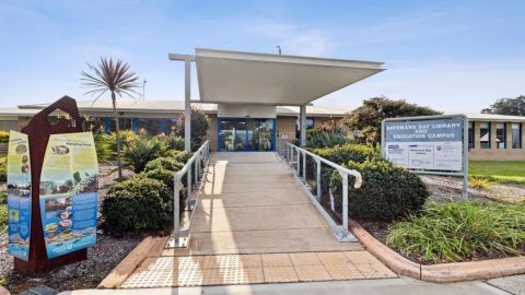 Accessible ramp entrance to Batemans Bay Library and Education Campus surrounded by landscaped gardens.