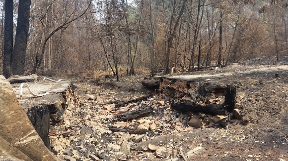 Image A large hole and few charred remains are what the fire left behind