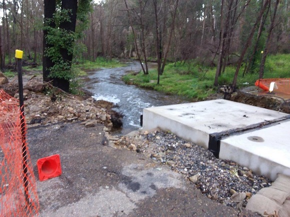 Image Flood waters flow through newly placed concrete box culverts