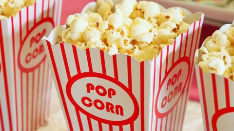 A container of popcorn at the movies ready for sale.