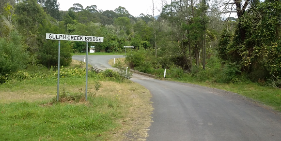 Image Gulph Creek Bridge is surrounded by lush green vegetation