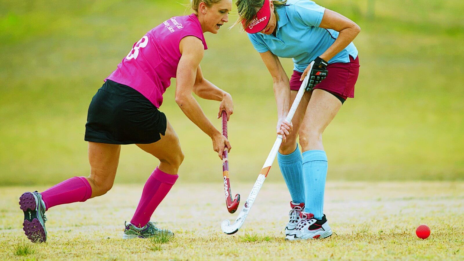 Two women playing hockey banner image