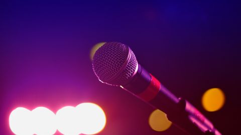 A microphone lit up with stage lighting effects.