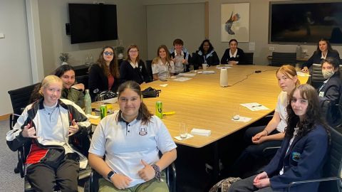 group of teenagers sitting around a table