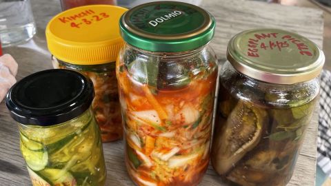 Close up image of preserved vegetables in glass jars