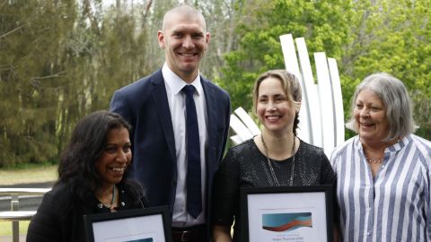 Four people smiling 