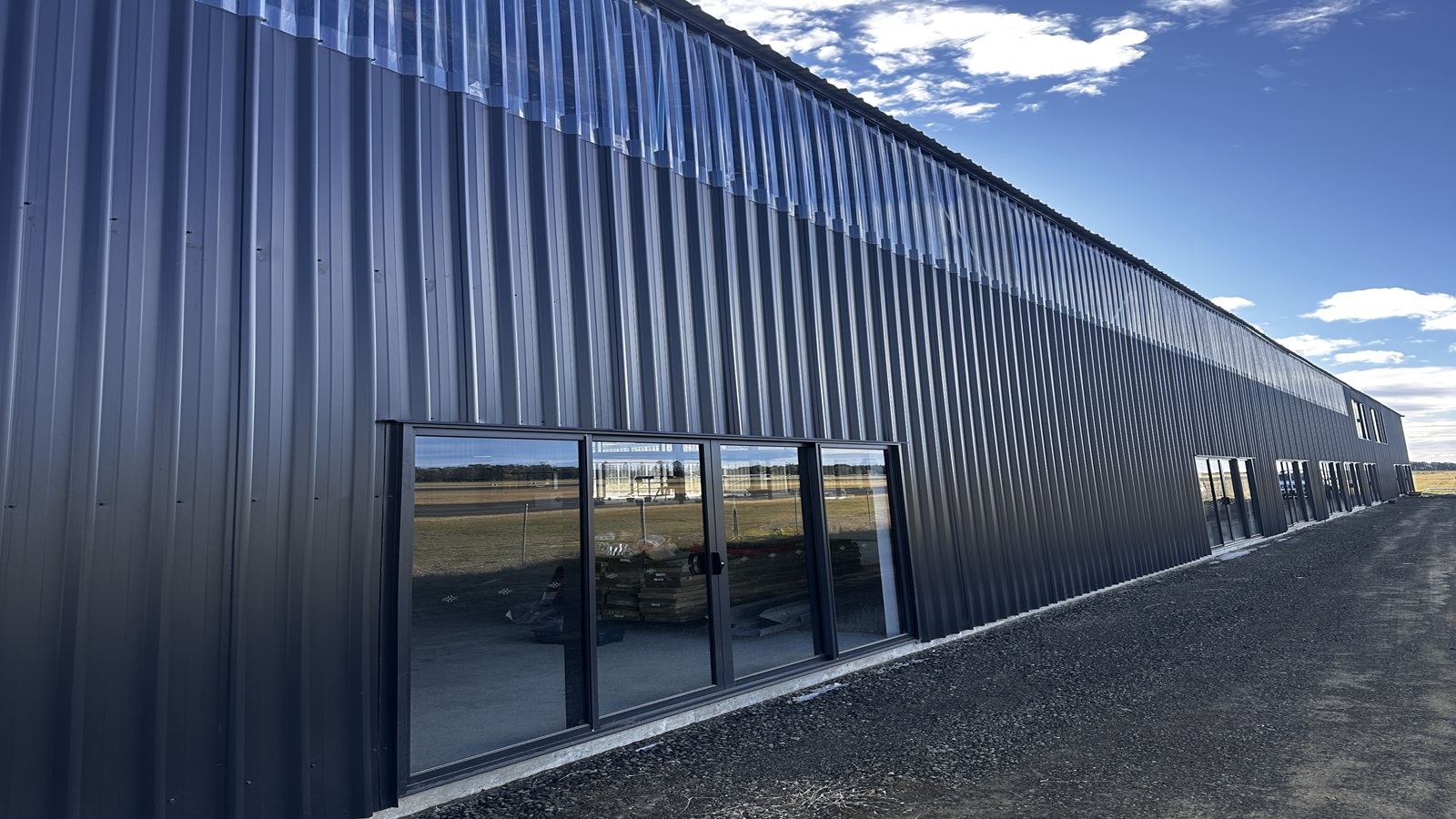 Image Windows along the exterior of the Mourya Shellfish Hatchery building.