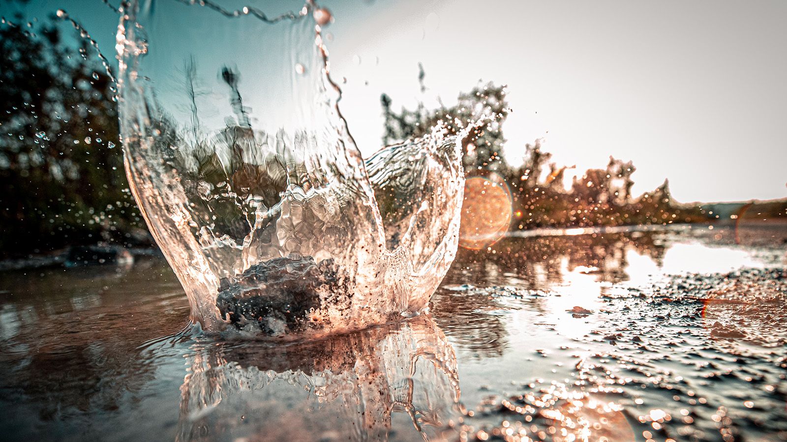 Water splash in a shallow river banner image