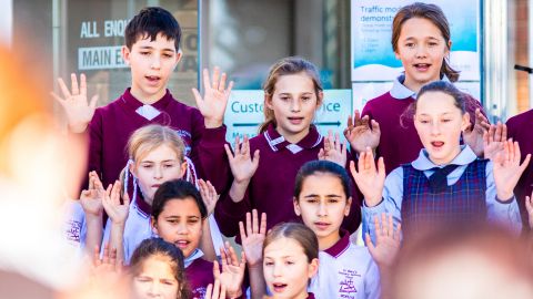 Eight students in Saint Mary's school uniforms perfoming a song