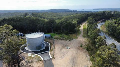 A reservoir overlooking bushland and the ocean