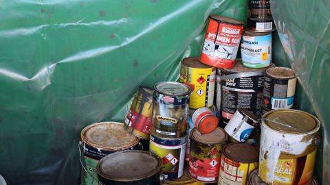 a pile of paint tins stacked up