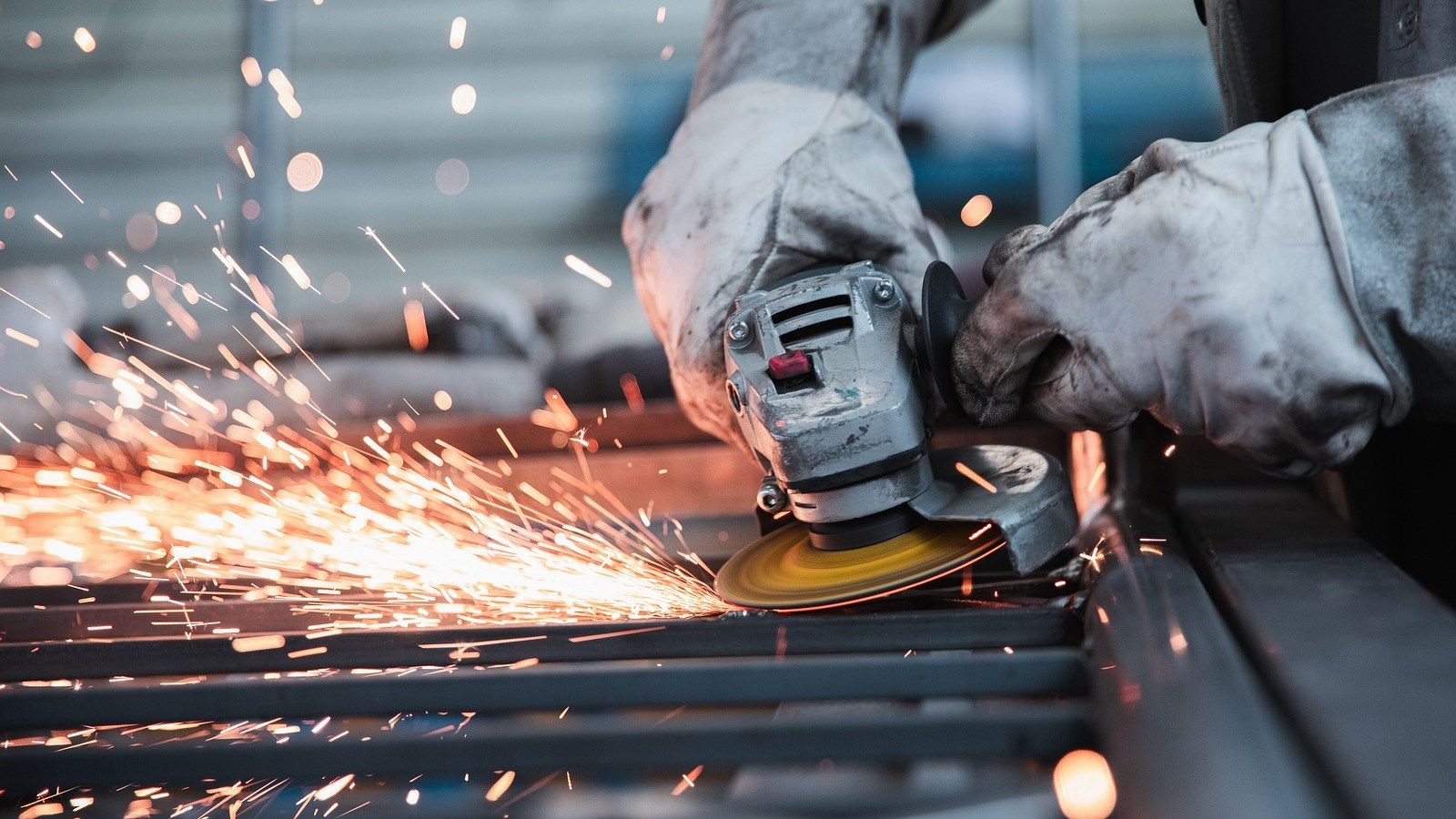 Close up image of a grinder power tool with sparks flying banner image