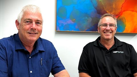 Two old white guys sitting at a table