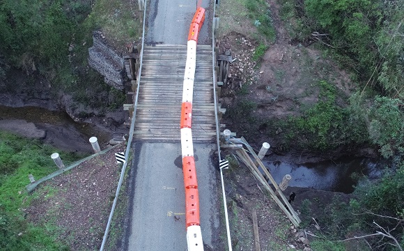 Image A drone photo shows damage caused to the abutments on one sides of the bridge