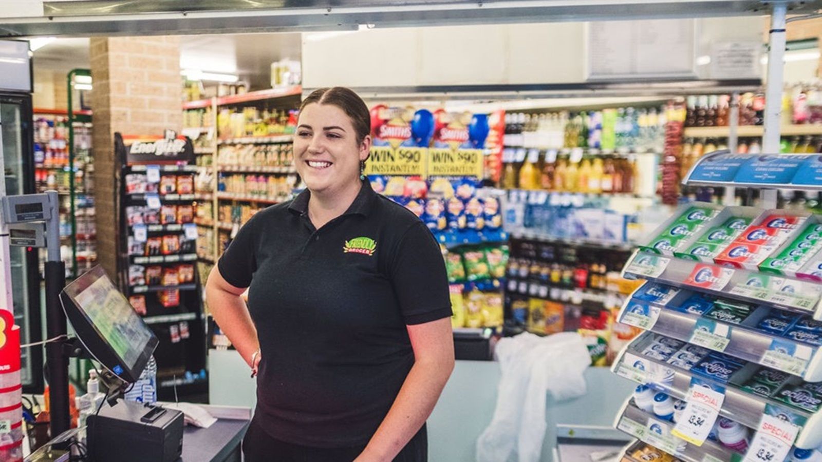 Local grocer check out staff member smile banner image