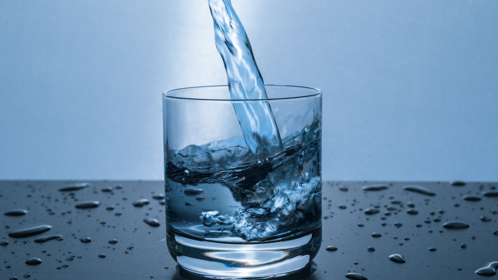Glass of drinking water on a bench banner image