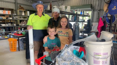 two adults and two children with a trolley 