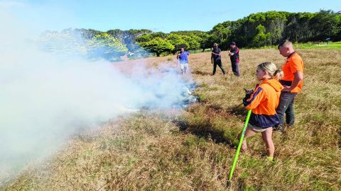 Staff monitoring a controlled burn to prepare for bushfire season.