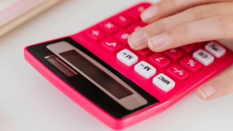 Image of a hand resting on a calculator