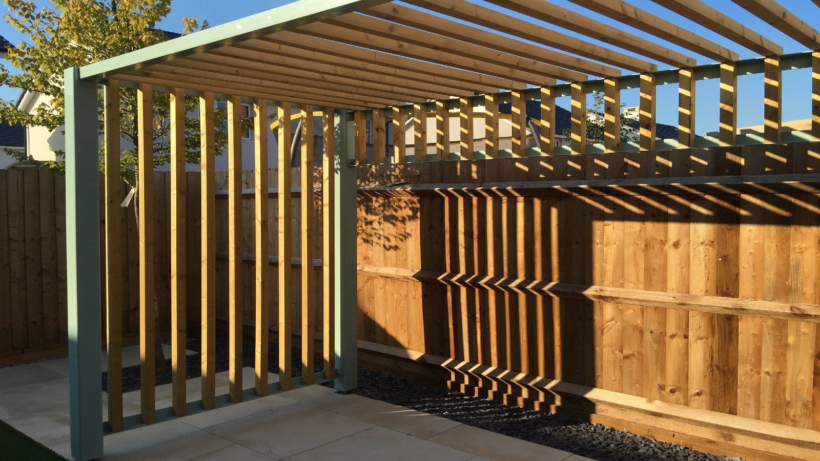 Pergola built against a timber backyard fence. banner image