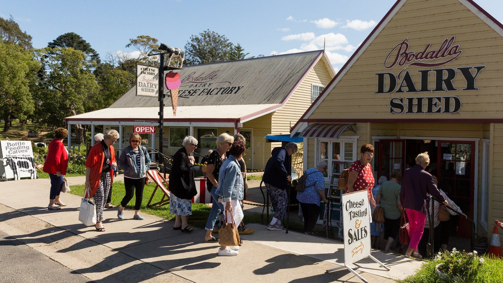 Group of women walking on the path outside the Bodalla Dairy Shed. banner image
