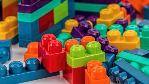 A pile of coloured building blocks.