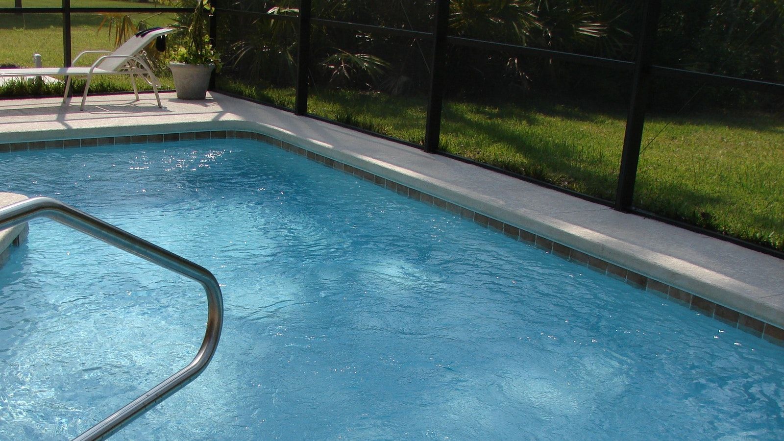 Swimming pool next to pool fence banner image