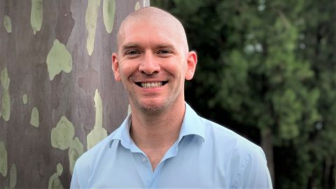 Head shot of man in blue shirt