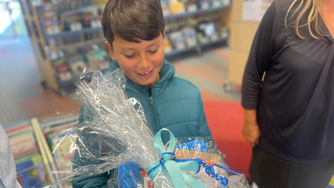 boy holding prize wrapped in plastic