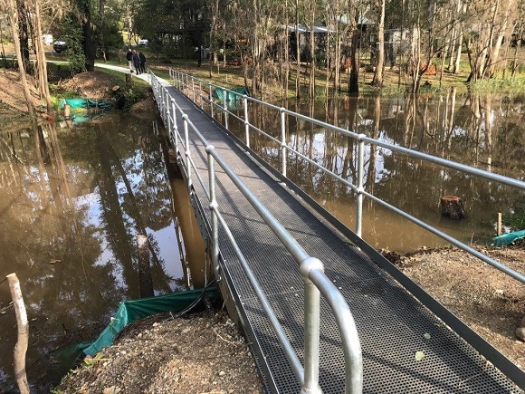 Image A new steel footbridge crosses a creek