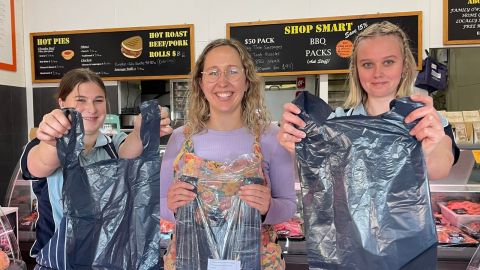 Holding plastic bags inside Southlands Butchery
