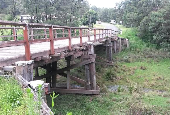 Image The timber bridge sits high above the creek