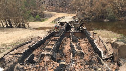 A burnt bridge over a river.