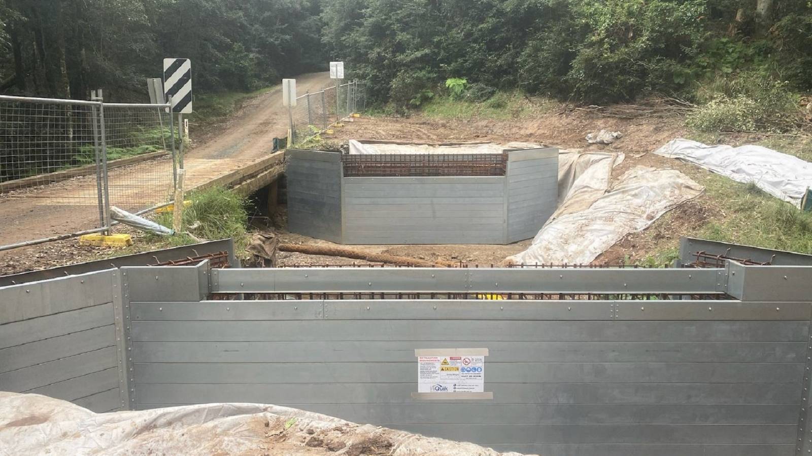 A construction site shows aluminum bridge abutments in place.